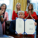 Trump shows one of two executive orders aimed at supporting women in STEM fields on Feb. 28, 2017, in the Oval Office.
